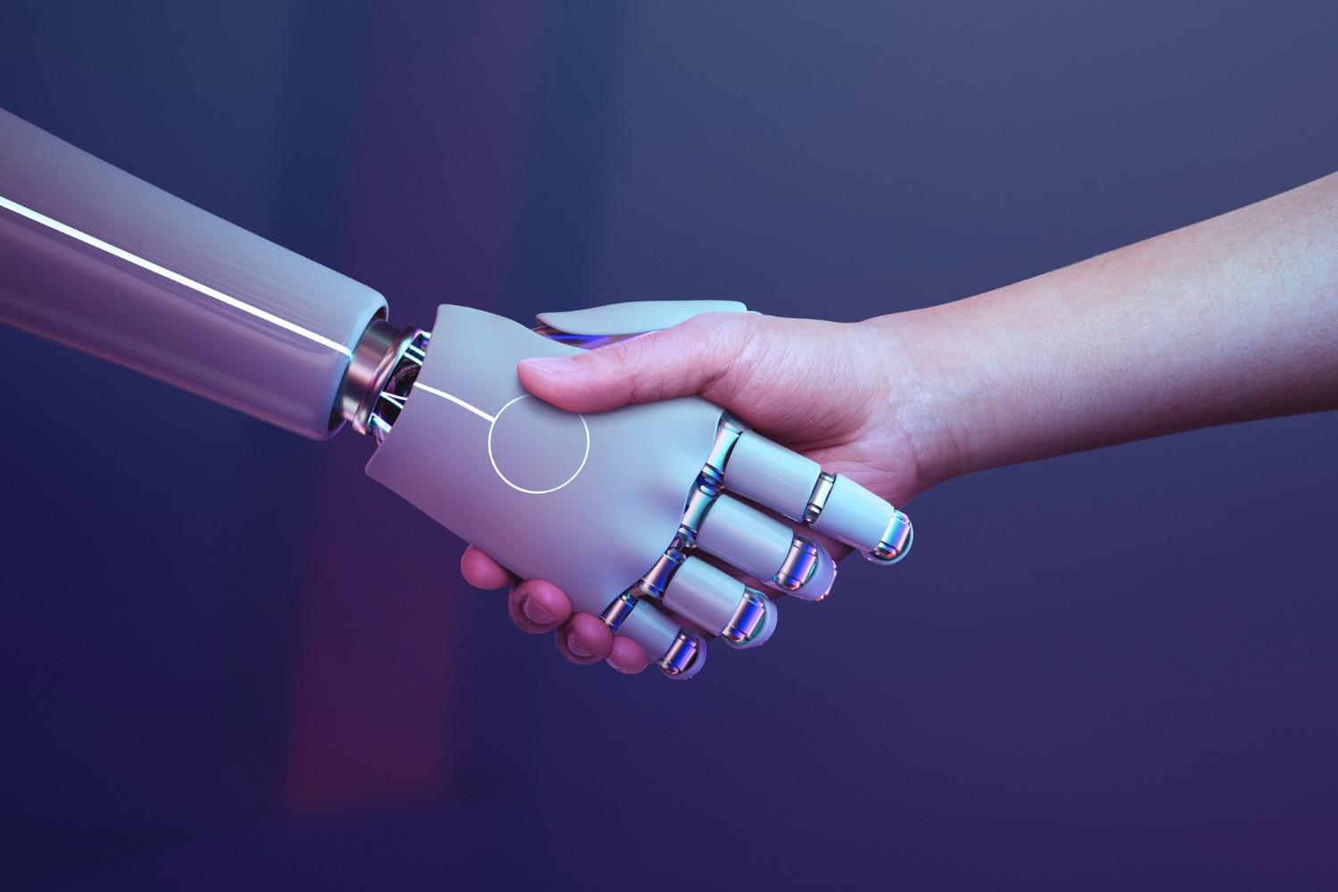 A person's hand shaking a robot's hand