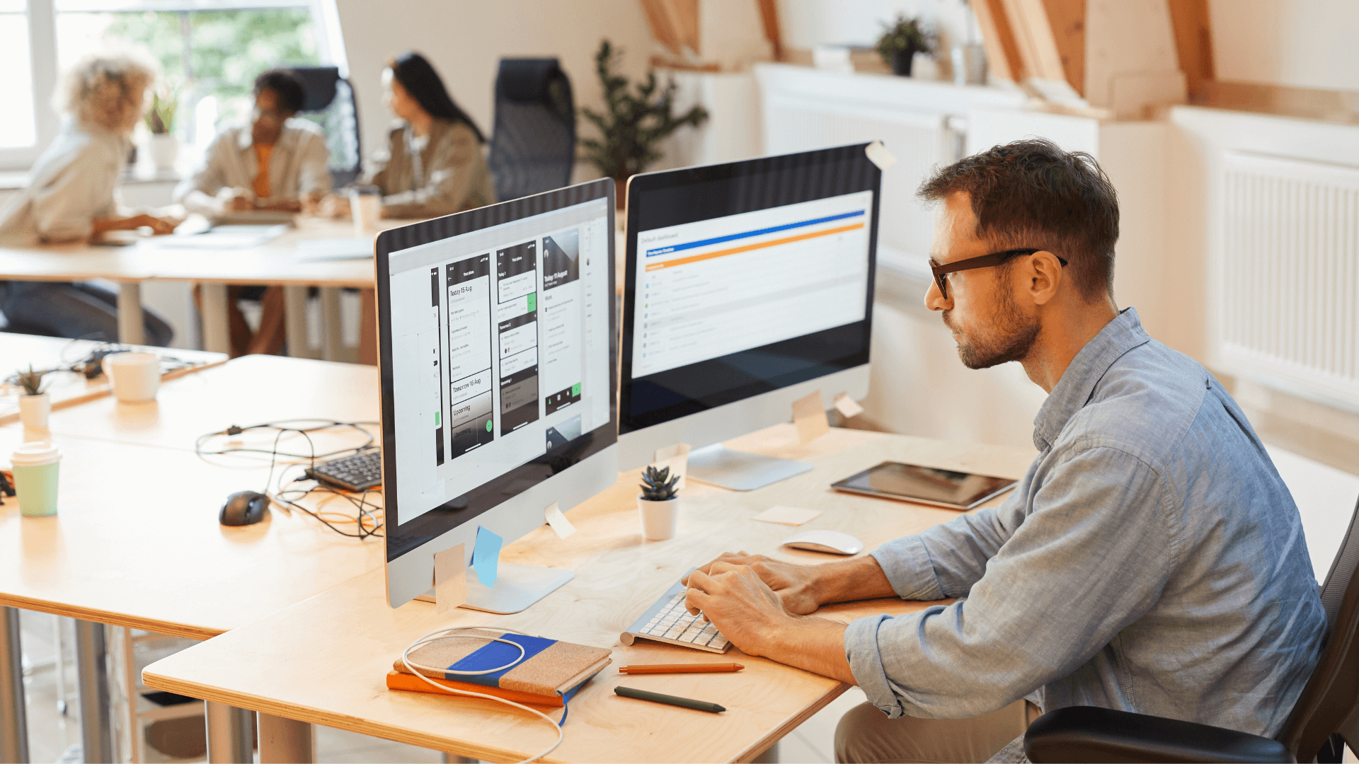 A person using two computer monitors while checking virtual copy of revenues