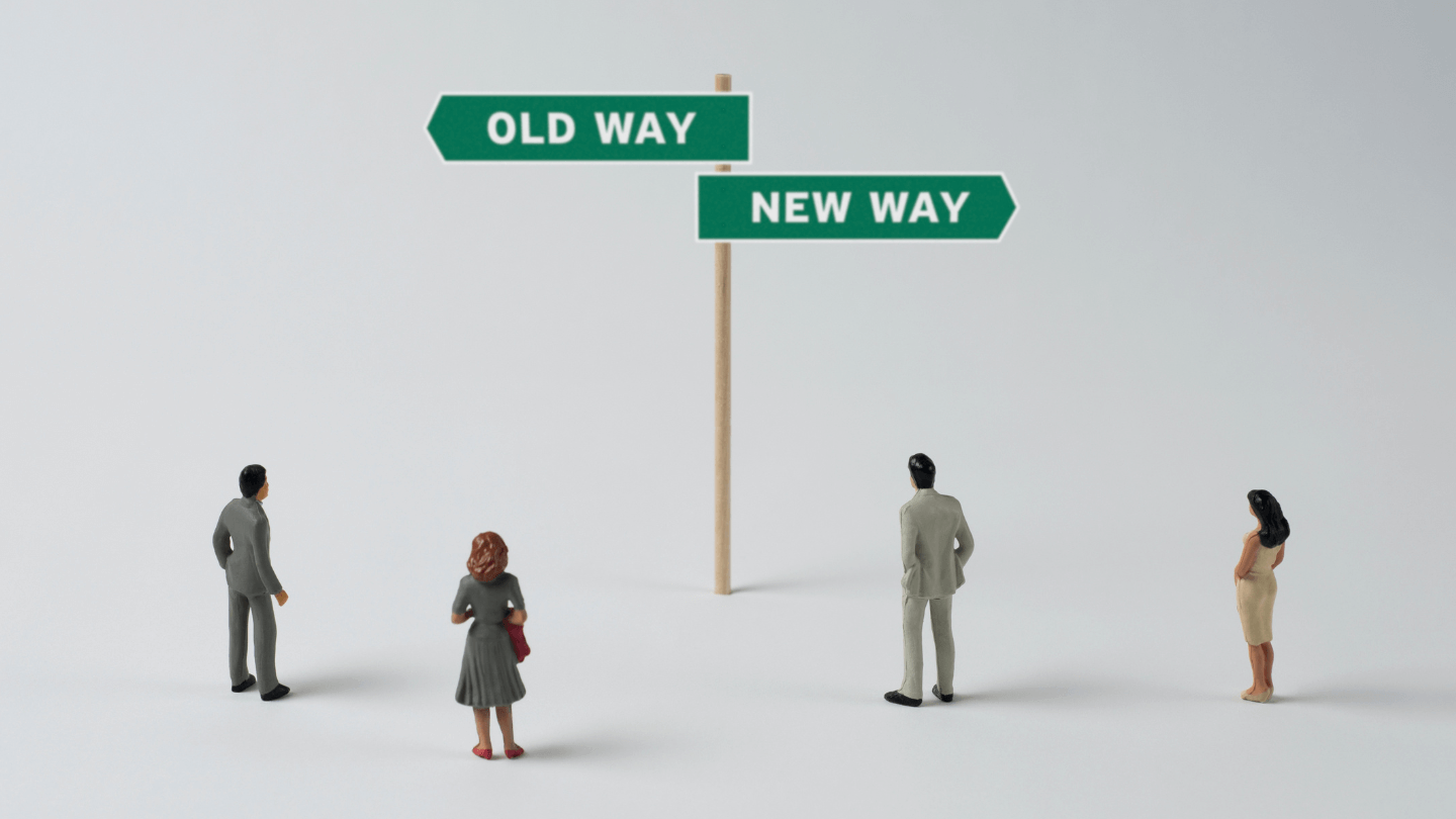 People looking on the signage showing Old Way and New Way both pointing to a different direction