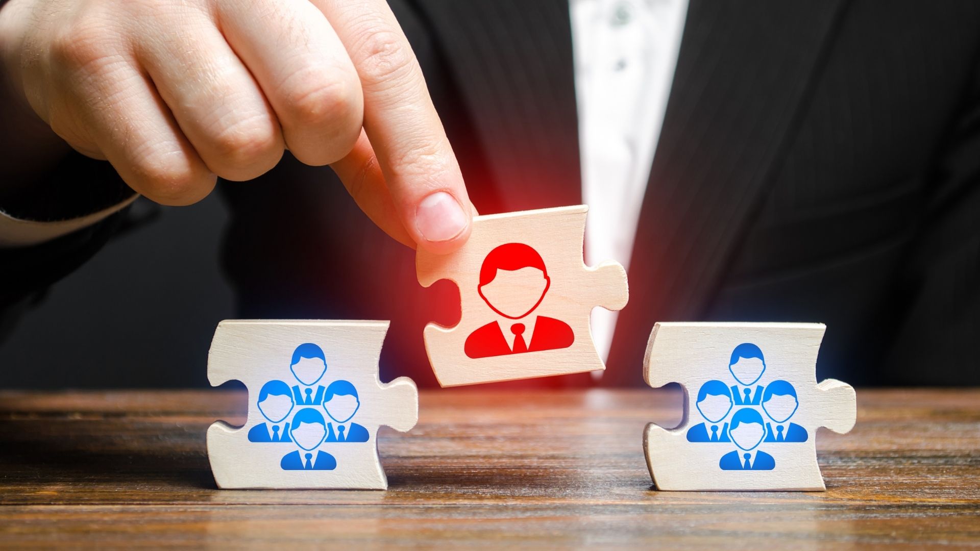 A person putting a different colored puzzle piece which illustrates the power of connecting the right people