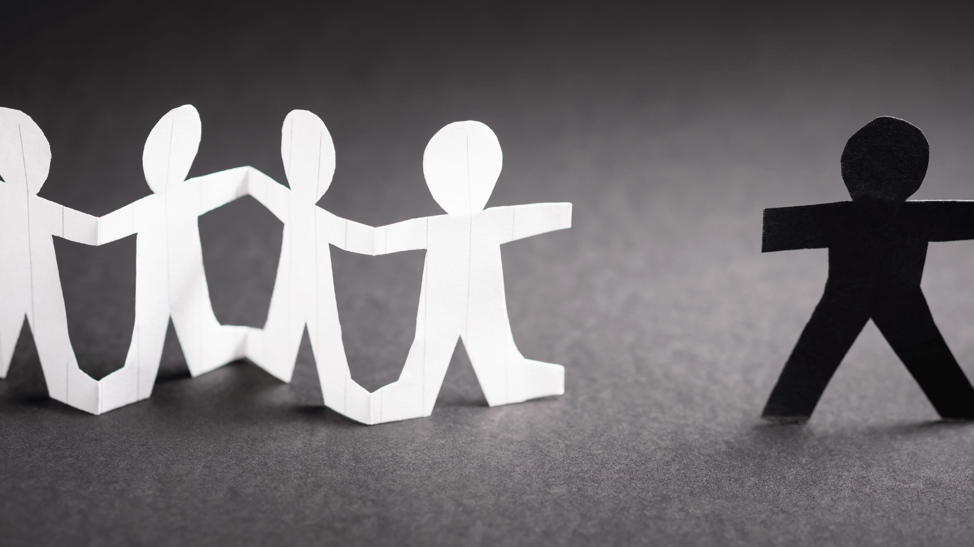 Human-like figure using a paper cut with 4 white papers while the other one is separated