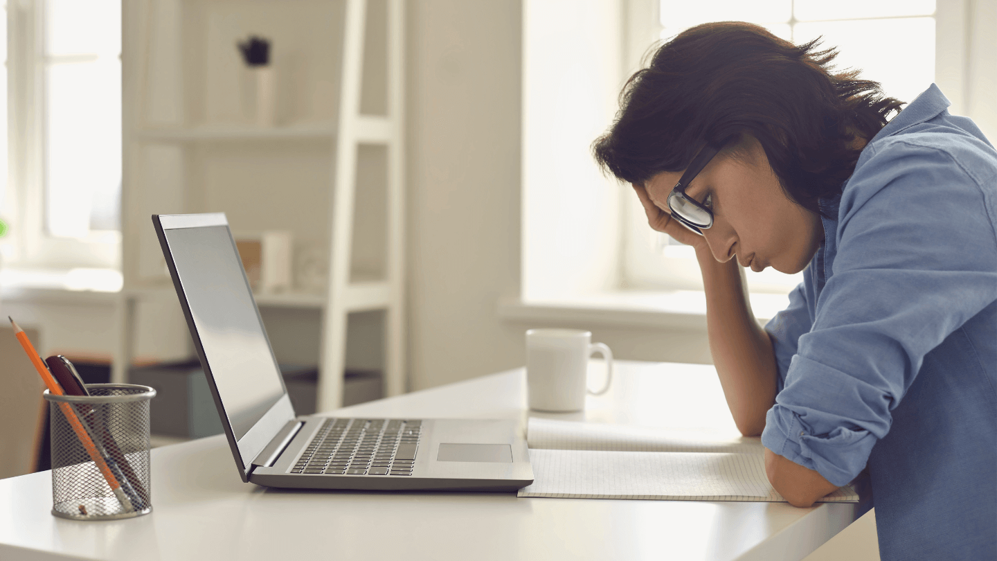 A woman having a hard time thinking while in front of her laptop
