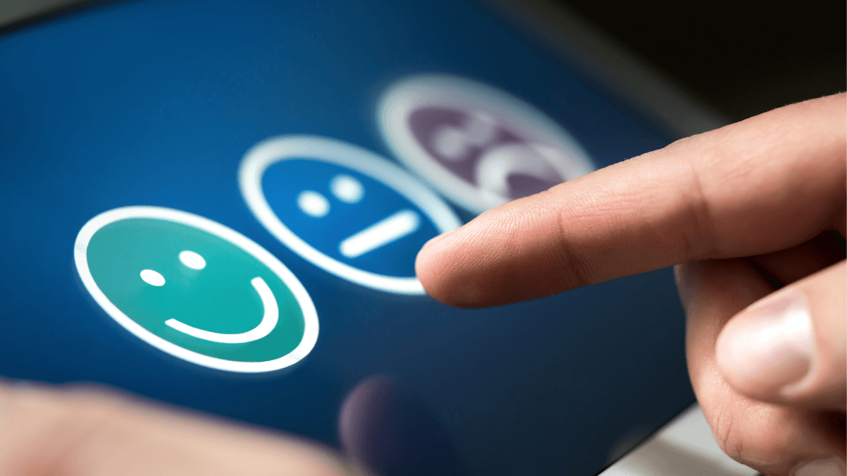 A person's finger on a phone screen choosing which emotions best describes the experience