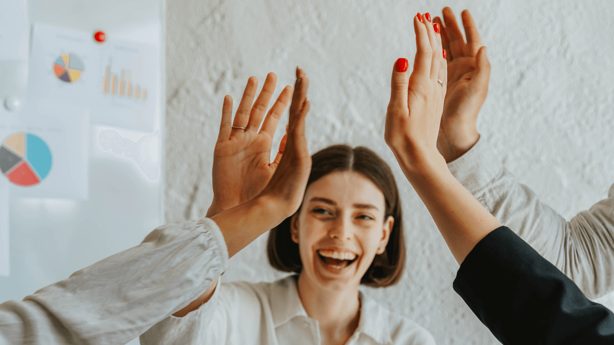Group of happy employees doing a high five
