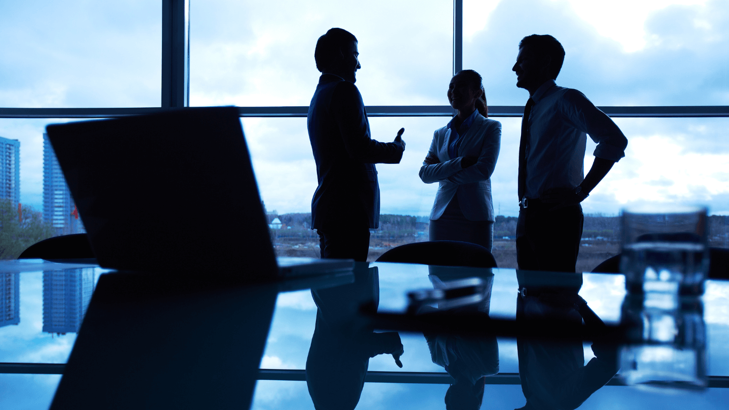 Three employees having a meeting