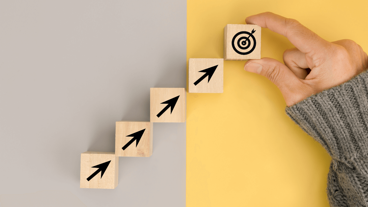 A wooden block going upward until the target representing the steps to reach goals