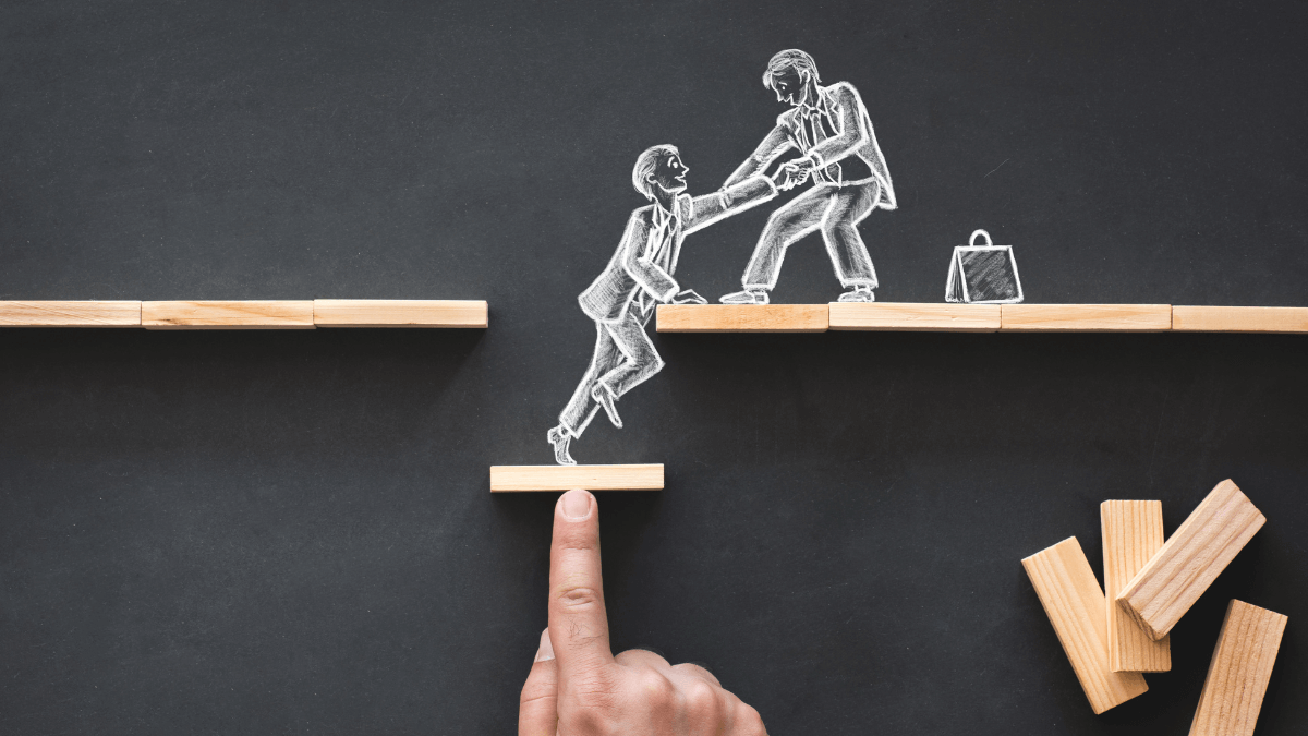 A person helping another person by lifting them up the platform