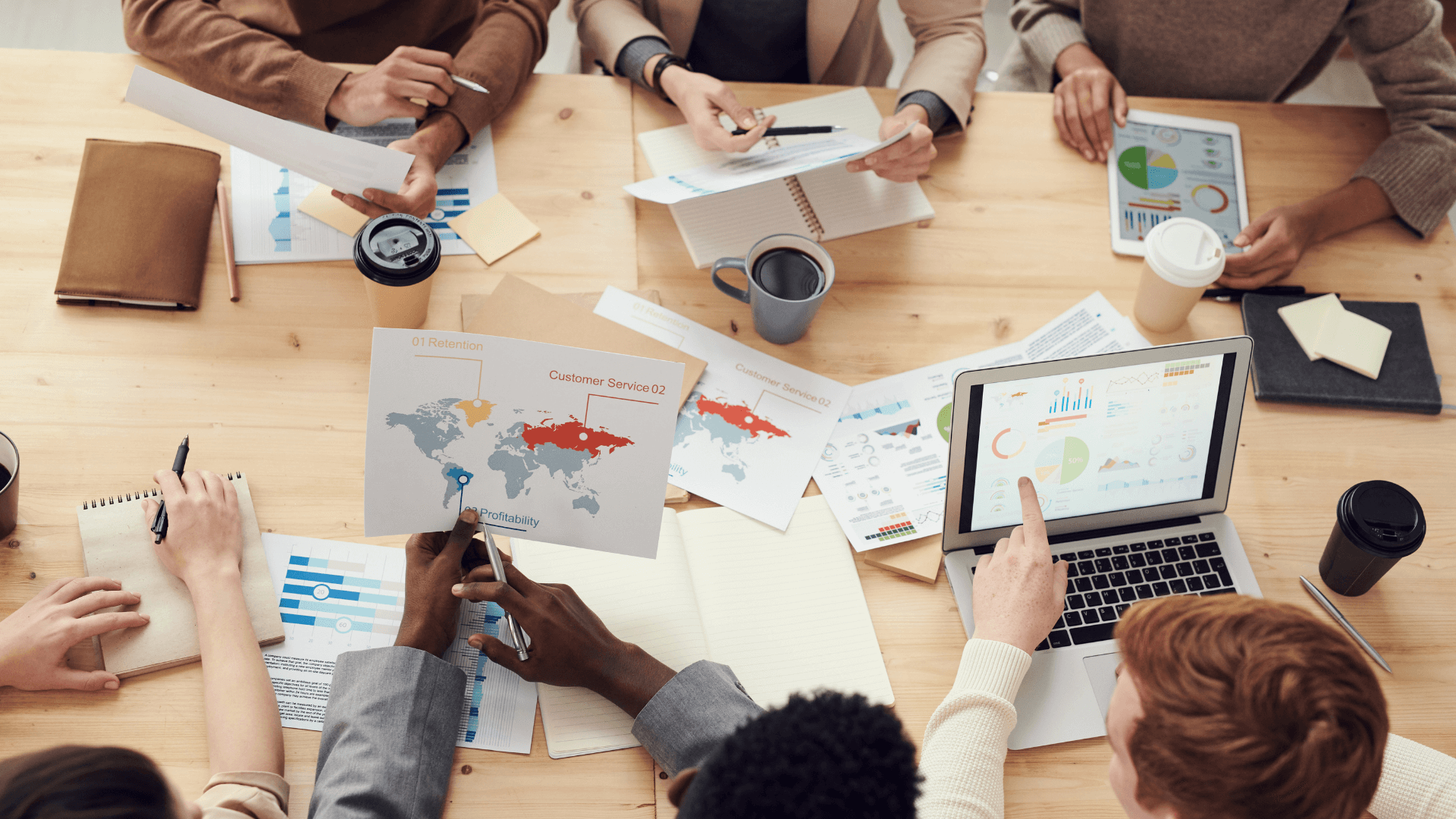 Group of employees having a meeting using graphs, analytics, and locations