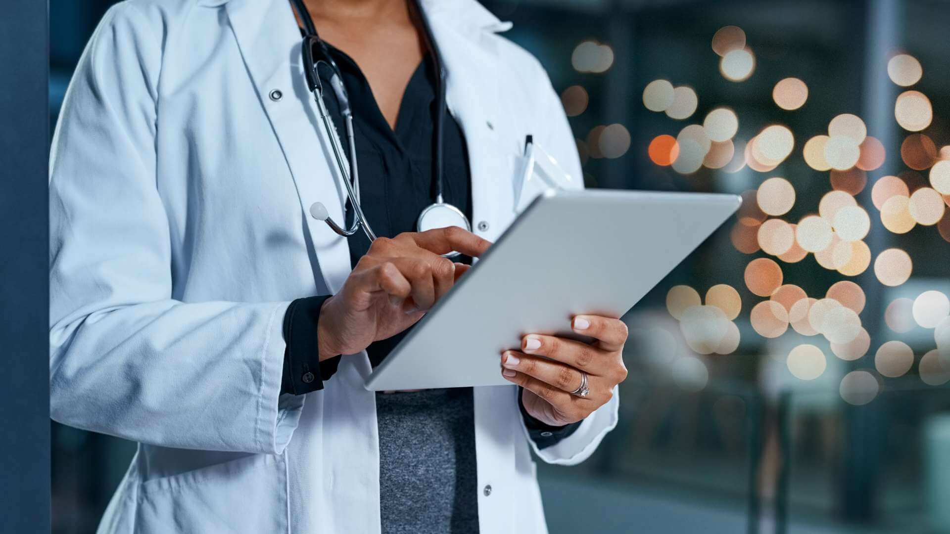 A healthcare professional holding a tablet phone