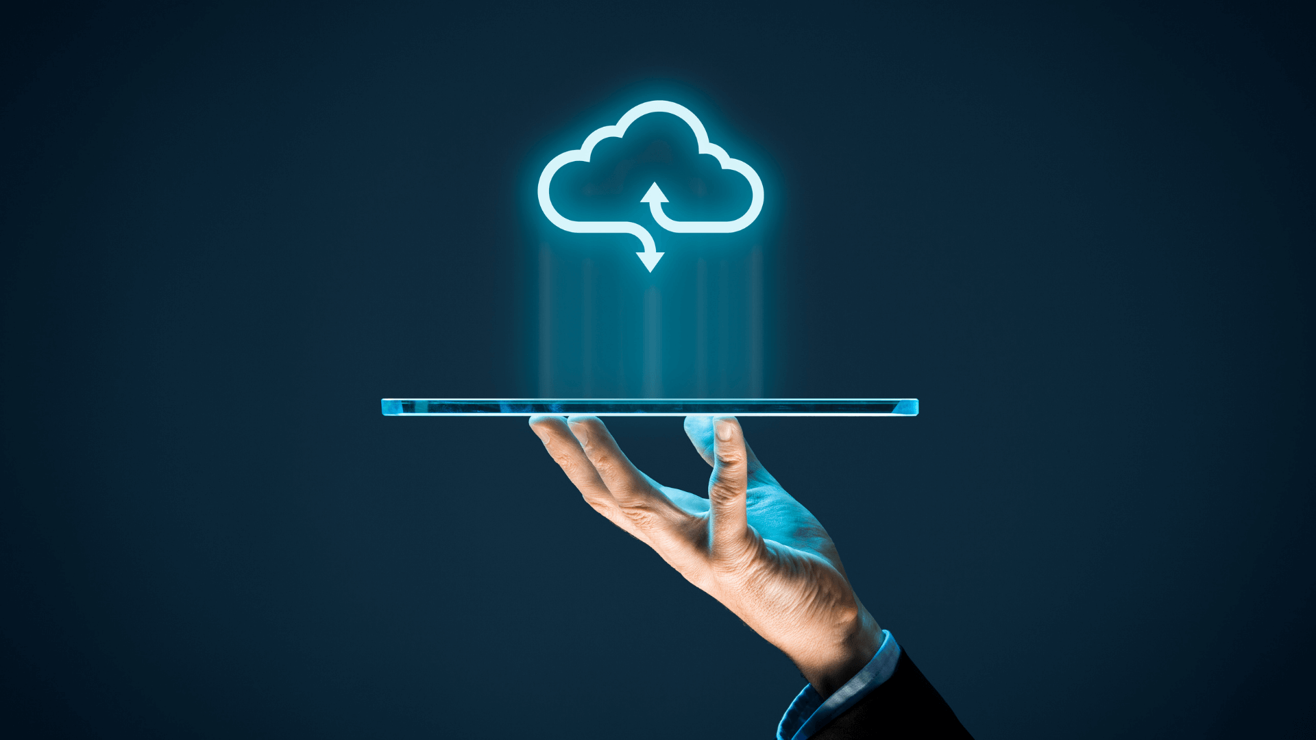 A person holding a portable tablet displaying a cloud upload icon